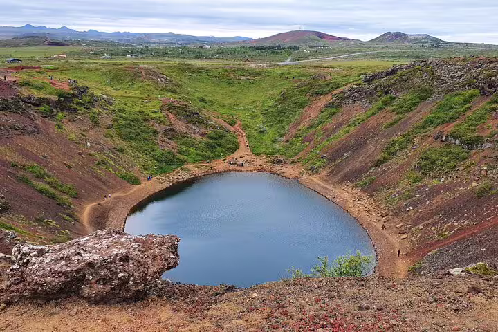 Kerid volcanic crater lake on Iceland's Golden Circle with red lava rock and green landscape