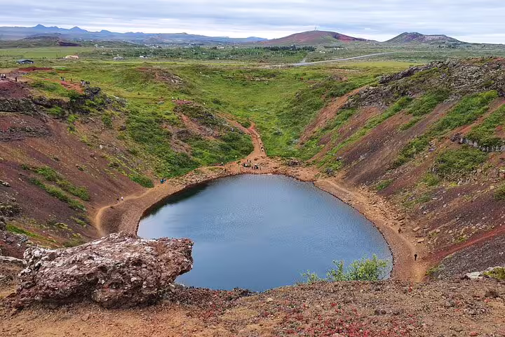 Kerid volcanic crater lake with red lava rock walls on Iceland's Golden Circle route