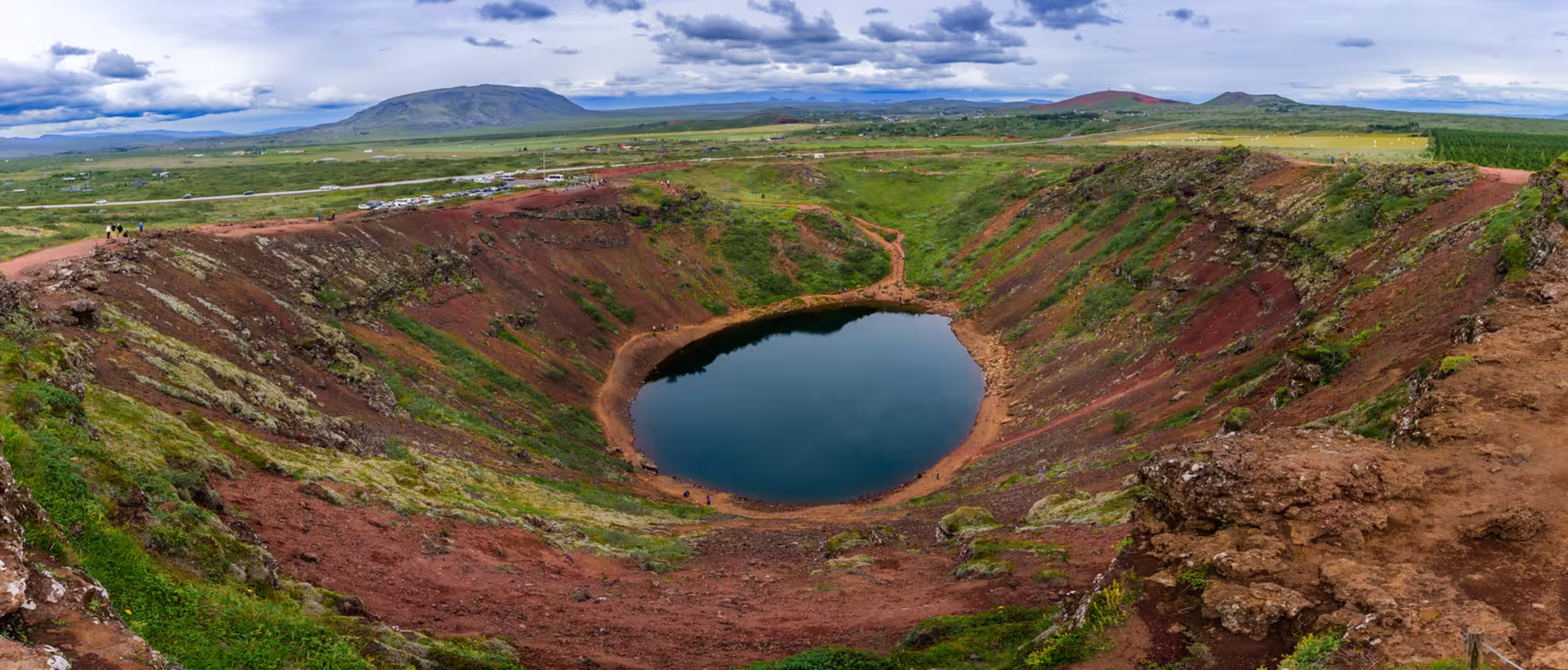 Kerid volcanic crater lake with red walls and green landscape on Iceland's Golden Circle route