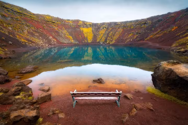 Kerid volcanic crater lake with turquoise water and red rocky walls on Iceland's Golden Circle