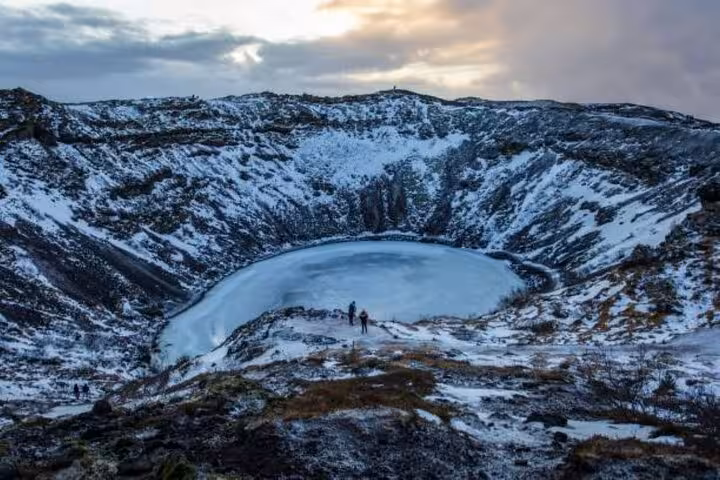 Kerid volcanic crater lake covered in snow and ice during winter on Iceland's Golden Circle route