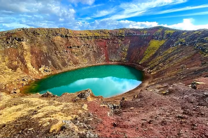Turquoise crater lake Kerid with red volcanic walls on Golden Circle tour Iceland