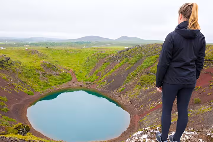 Woman overlooking Kerid volcanic crater lake on Golden Circle tour from Reykjavik, Iceland