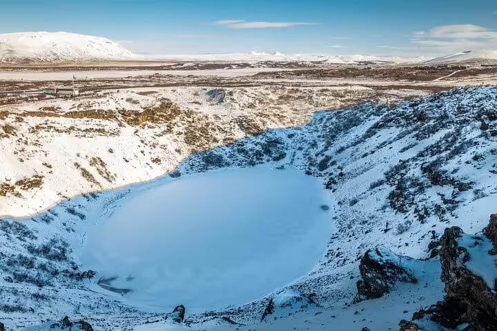 Frozen volcanic crater lake covered in snow during winter in Iceland's Golden Circle