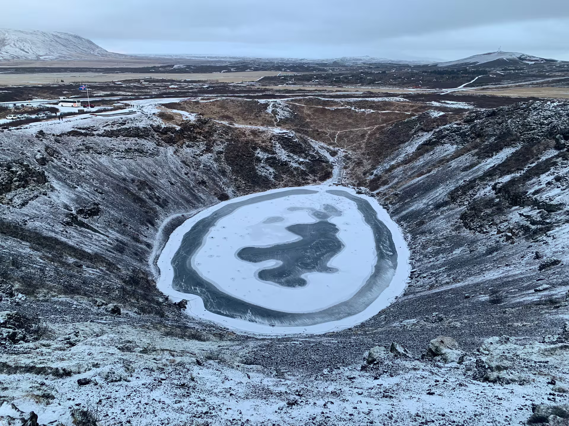Frozen volcanic crater lake Kerið covered in snow during winter Iceland Super Jeep tour