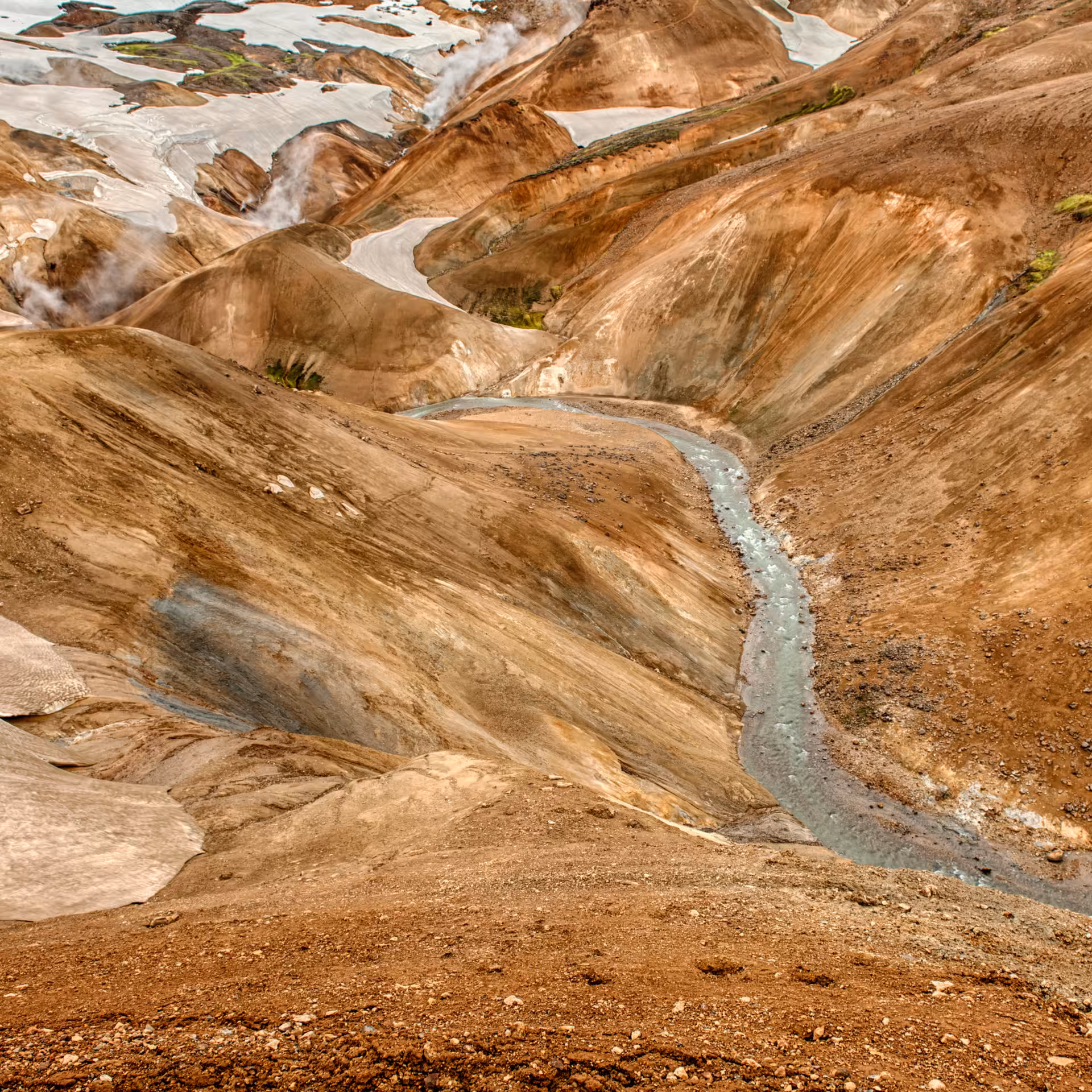 Stunning Kerlingarfjoll geothermal valley with winding glacial river and colorful rhyolite mountains in Iceland highlands