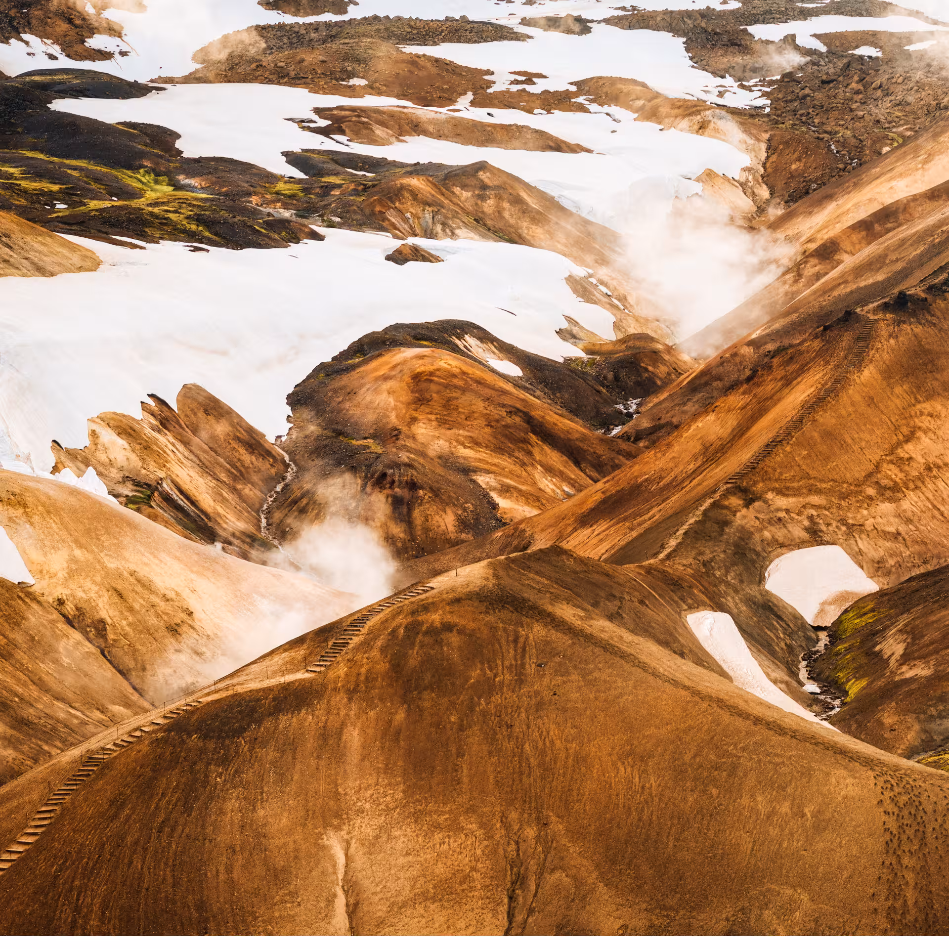 Aerial view of Kerlingarfjoll colorful rhyolite mountains with snow and geothermal steam on Iceland 4x4 day tour from Reykjavik
