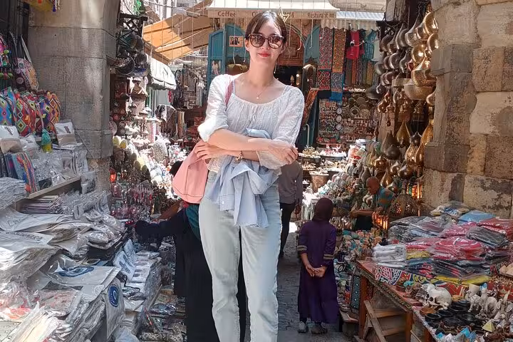 Traveler browsing stalls in Khan El Khalili bazaar, Cairo day tour with local market shopping experience