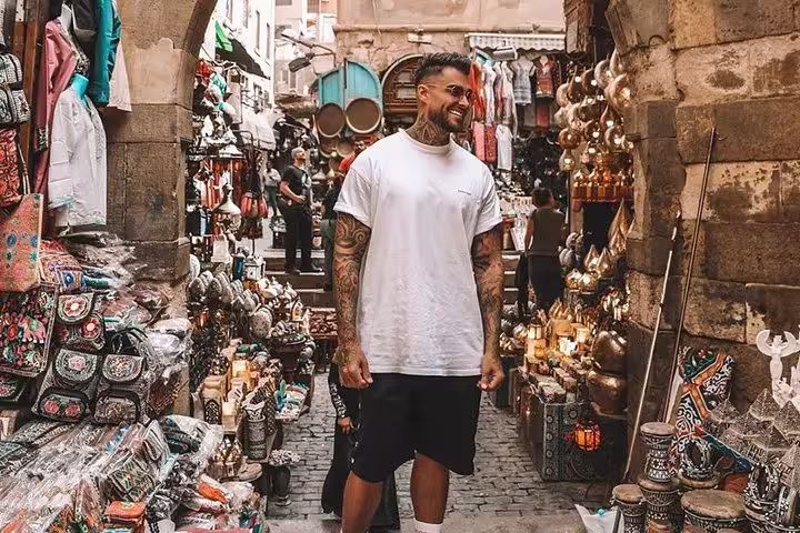 Visitor exploring Khan El Khalili bazaar in Old Cairo, shopping souvenirs on Egyptian Museum and Citadel tour