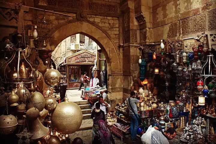 Khan El Khalili bazaar alley with hanging brass lanterns and souvenirs on Cairo city tour from Port Said