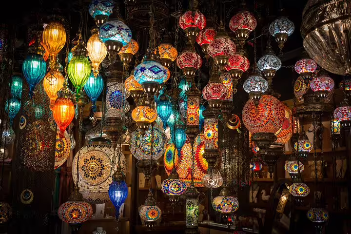 Colorful mosaic glass lanterns hanging in Khan El Khalili bazaar on El-Moez Street Cairo tour