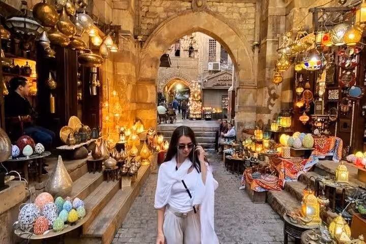 Traveler in Khan el-Khalili bazaar, Islamic Cairo walking tour with lantern shops and street food stops