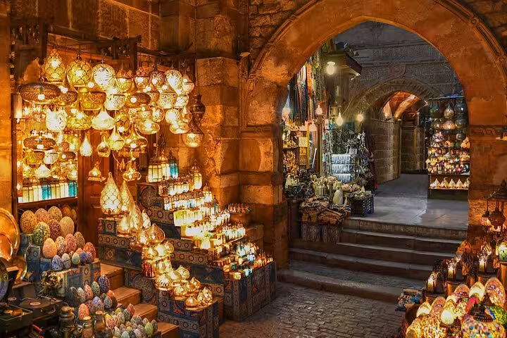 Khan el-Khalili bazaar lantern shop under stone archway, vibrant stop on Historic Islamic Cairo walking tour