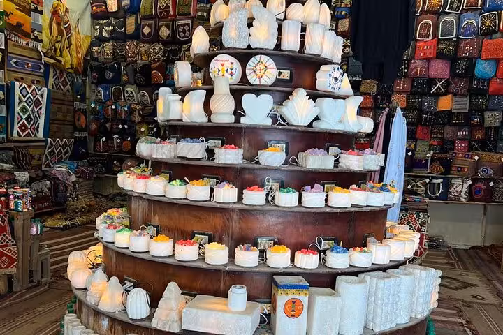 Alabaster souvenirs and colorful crafts stall in Khan El Khalili bazaar on a private Giza Pyramids day tour Cairo
