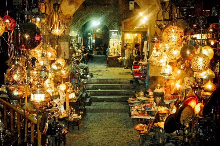 Brass lamps glowing in Khan El-Khalili market alley, Cairo, on guided Citadel and Coptic Cairo day tour