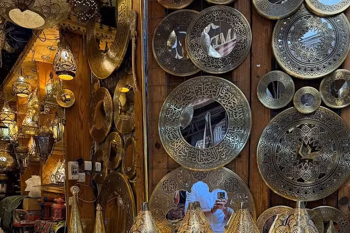 Engraved brass plates and lanterns at Khan el Khalili Market, Cairo shopping tour with koshary lunch