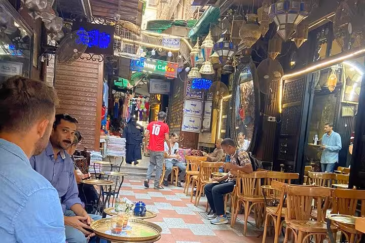 Khan el Khalili alley in Cairo with historic cafes and lanterns, part of guided market shopping tour with Koshary lunch