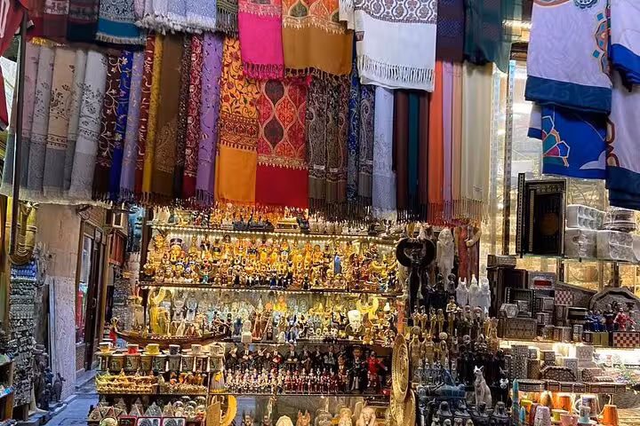 Colorful textiles and brass souvenirs at Khan el Khalili Market Cairo on a guided shopping tour with lunch