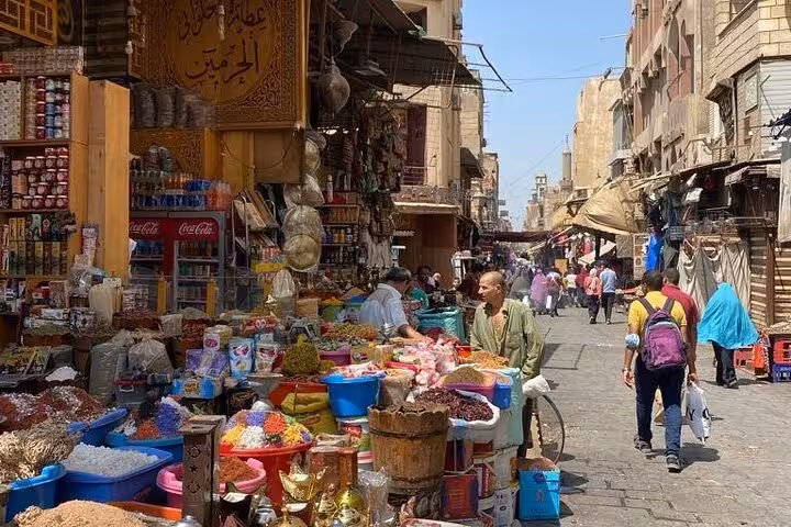 Bustling Khan El Khalili market street with spice stalls in Cairo, a stop on private Giza Pyramids and museum tour