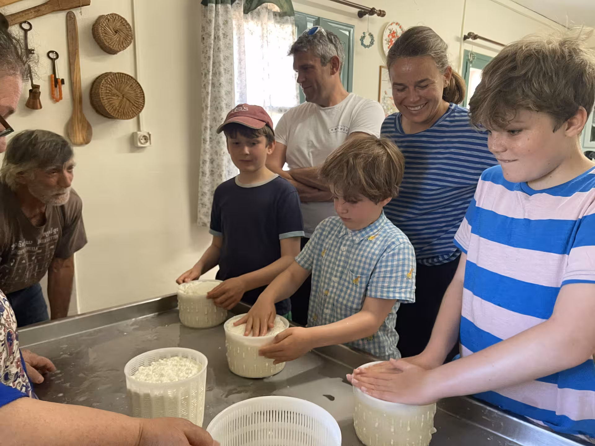 Children making fresh cheese in a farmhouse kitchen, hands-on cooking workshop for the Kids First tour