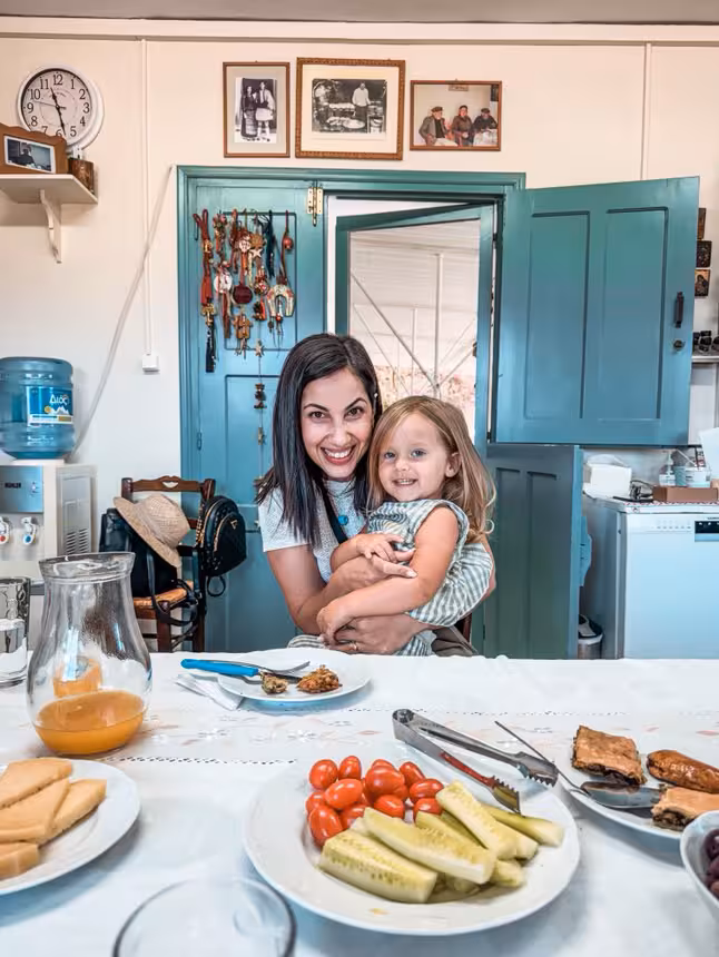 Happy mom and child enjoying a family-friendly Kids First farm lunch with fresh local food at a rustic home