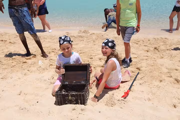 Kids in pirate bandanas with treasure chest on White Island beach during Sharm Ras Mohammed boat tour