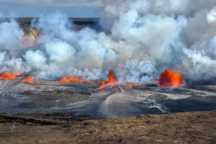Dramatic eruption of Kilauea Volcano on Big Island, with bright lava contrasting against smoky skies.