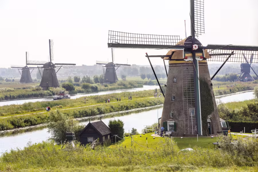 Kinderdijk UNESCO windmills by canal, highlight stop on private tour from The Hague, Leiden or Noordwijk