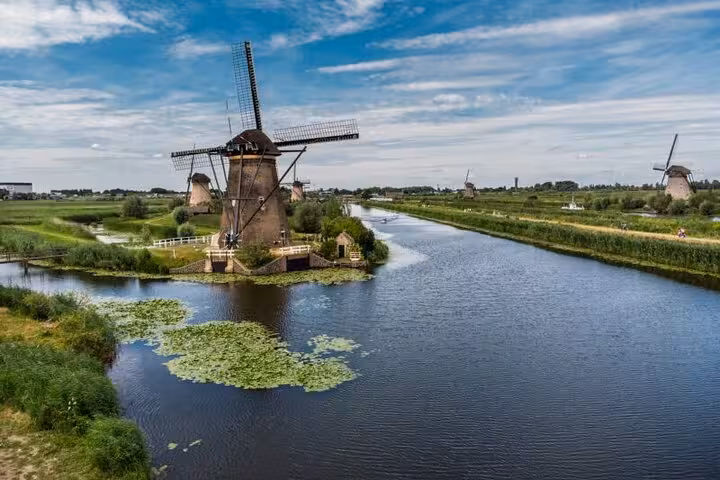 Kinderdijk UNESCO windmills beside Dutch canals, scenic highlight on a private tour from Rotterdam to Delft and The Hague
