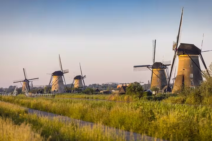 Kinderdijk windmills at sunset on Famous Holland day tour from Amsterdam via Rotterdam, Delft and The Hague