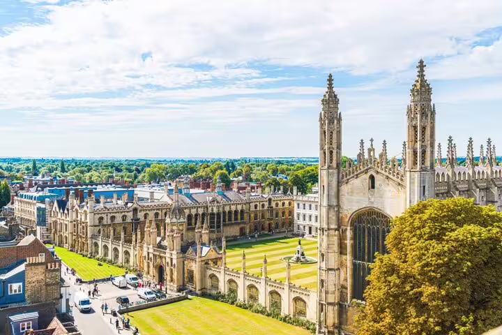 Aerial view of King's College Cambridge with Gothic chapel towers and manicured lawns