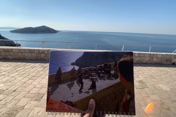 Game of Thrones scene photo held at Dubrovnik seaside viewpoint on King's Landing streets walking group tour