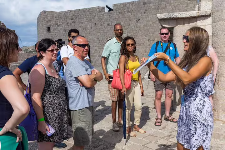 Guide briefing group at Dubrovnik city walls on King’s Landing streets walking tour, Game of Thrones filming spots