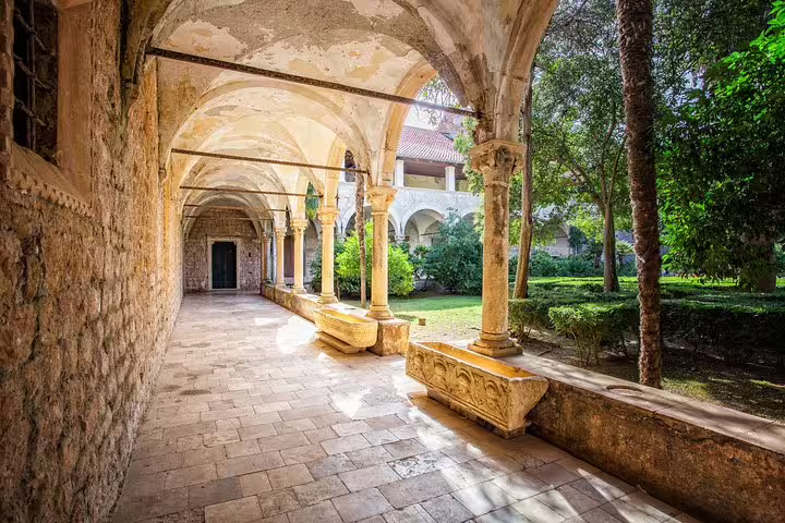 Historic stone cloister walkway in Dubrovnik, filming location visited on King's Landing and Iron Throne tour