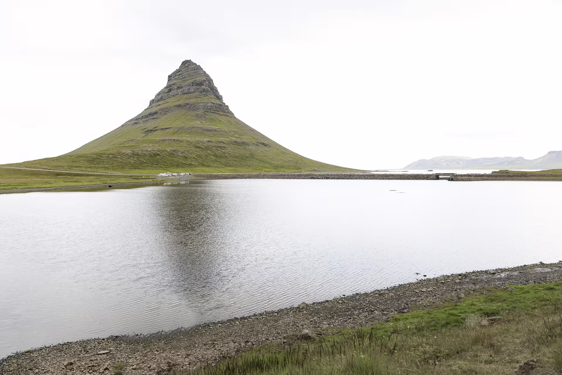 Kirkjufell mountain reflected in calm lake waters on Snaefellsnes Peninsula, Iceland