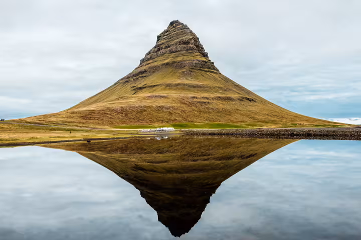 Kirkjufell mountain with perfect mirror reflection in calm water, Iceland