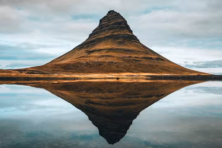 Kirkjufell mountain perfectly reflected in still water on Snaefellsnes Peninsula, Iceland