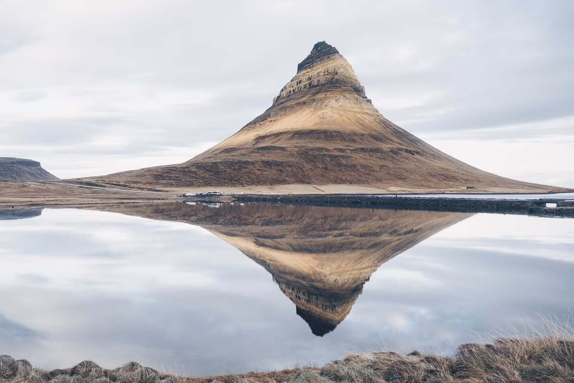 Kirkjufell mountain reflected in calm water on the Snaefellsnes Peninsula, Iceland