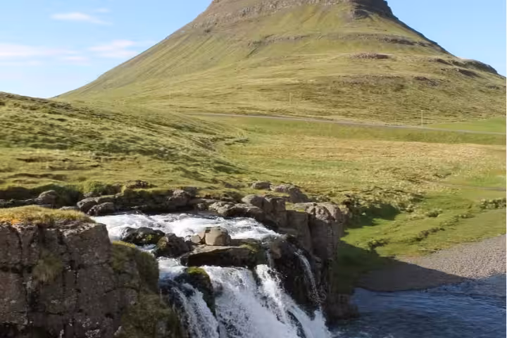Waterfall cascading over rocks with the iconic Kirkjufell mountain on Snaefellsnes Peninsula, Iceland