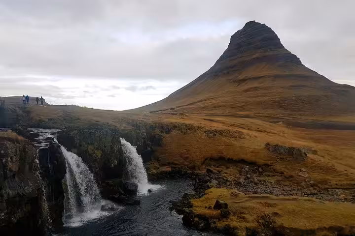 Kirkjufell mountain with Kirkjufellsfoss waterfall in Iceland's Snaefellsnes Peninsula on overcast day