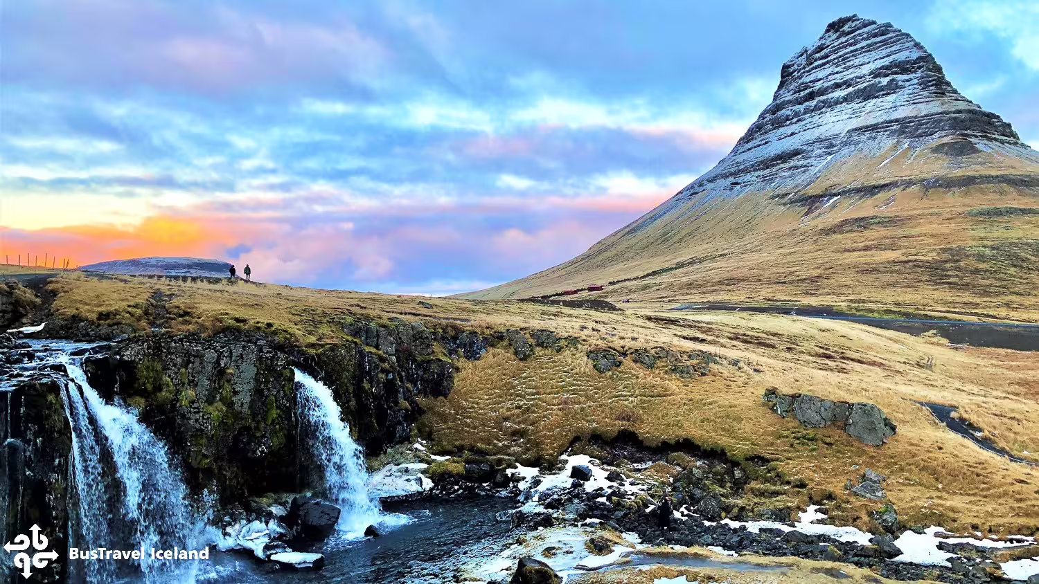 Kirkjufell mountain with waterfall and golden meadows on Snaefellsnes Peninsula, Iceland at sunset