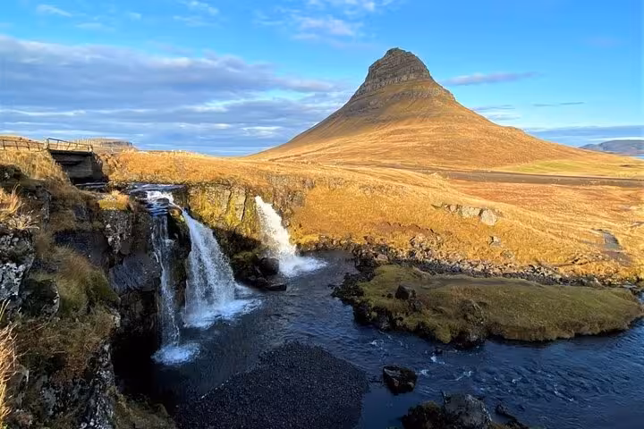 Kirkjufellsfoss waterfall cascading beside the iconic cone-shaped Kirkjufell mountain on Snaefellsnes Peninsula, Iceland