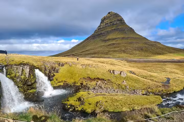 Kirkjufell mountain with waterfall and green landscape on Snaefellsnes Peninsula, Iceland