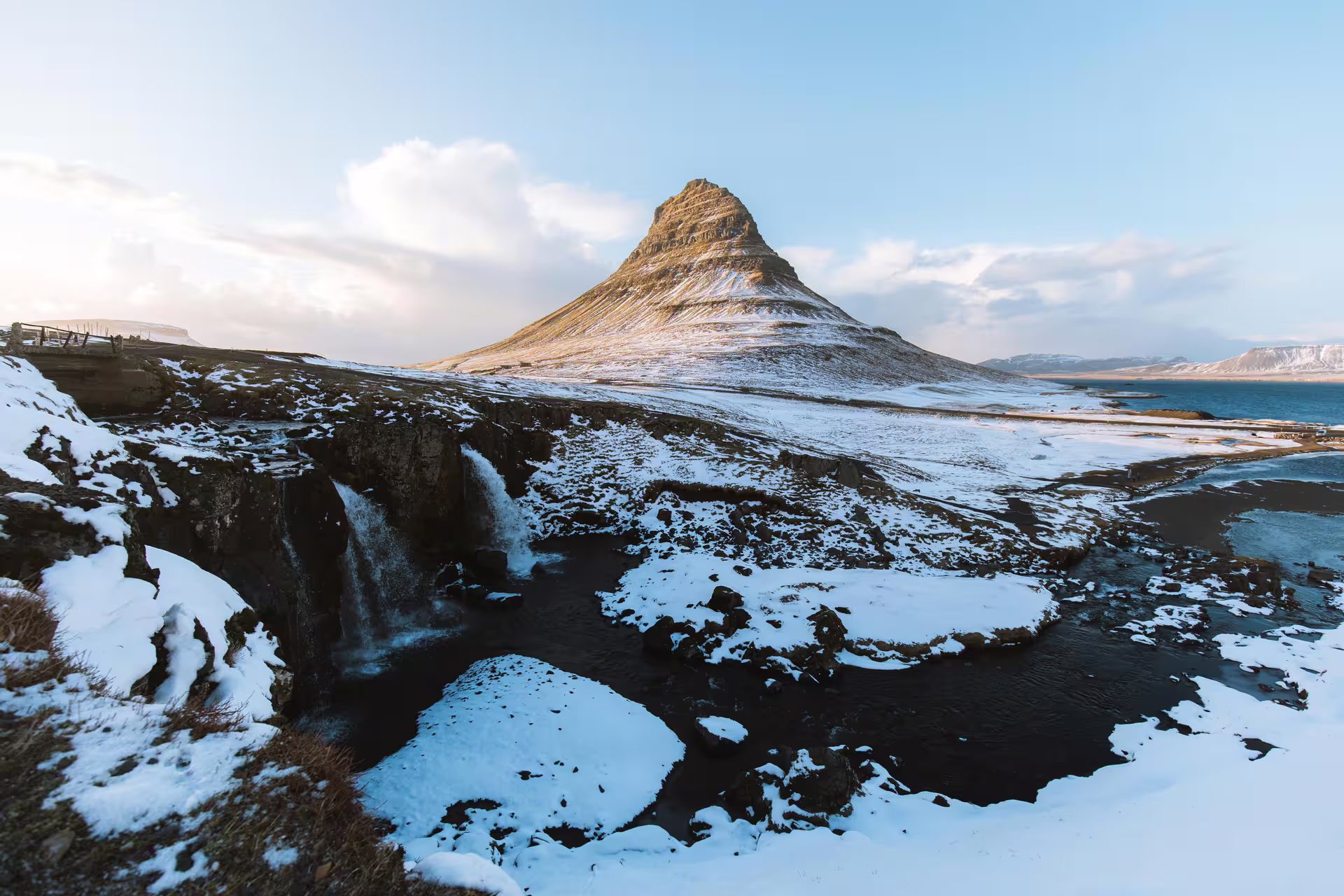 Kirkjufell mountain with snow and waterfall in winter, Iceland