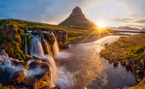 Kirkjufell mountain waterfall at golden sunset on Snaefellsnes Peninsula, Iceland