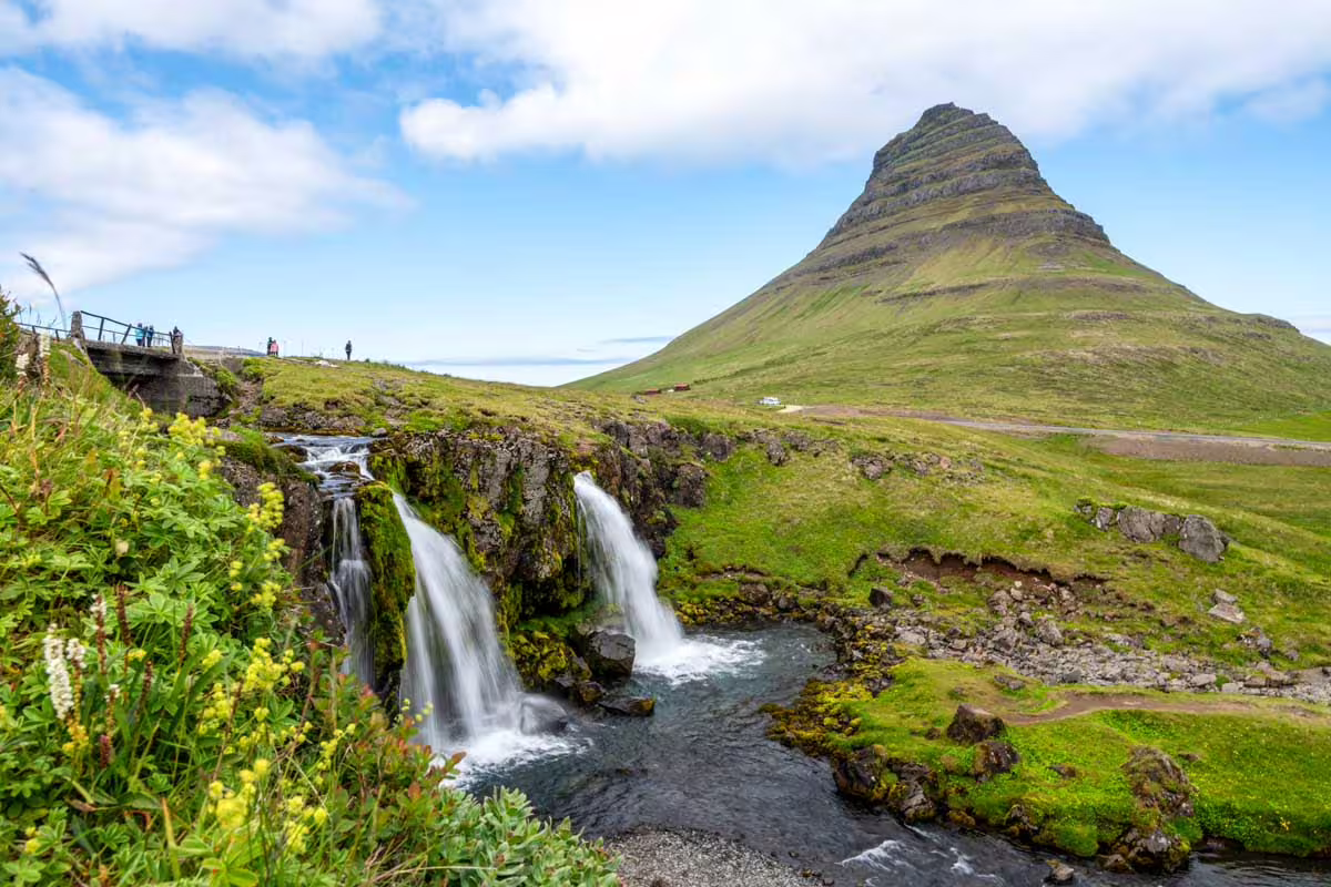 Kirkjufellsfoss waterfall cascading beside iconic Kirkjufell mountain on Iceland's Snæfellsnes Peninsula