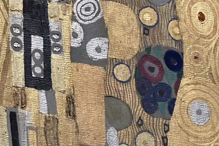 Close-up detail of Gustav Klimt's gold and patterned artwork, capturing the intricate textures and vibrant designs.