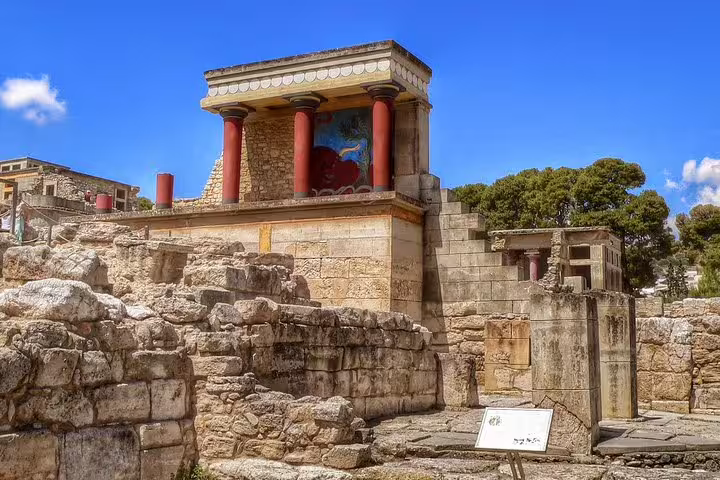 Restored red columns and frescoes at Knossos Palace ruins in Crete on a private skip-the-line half-day tour