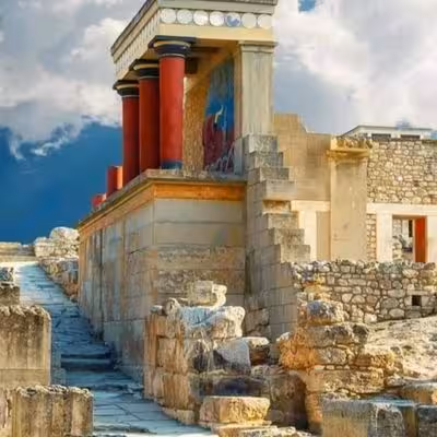 Restored Knossos Palace facade with red pillars and Minoan ruins, a highlight of Heraklion eco bike tour