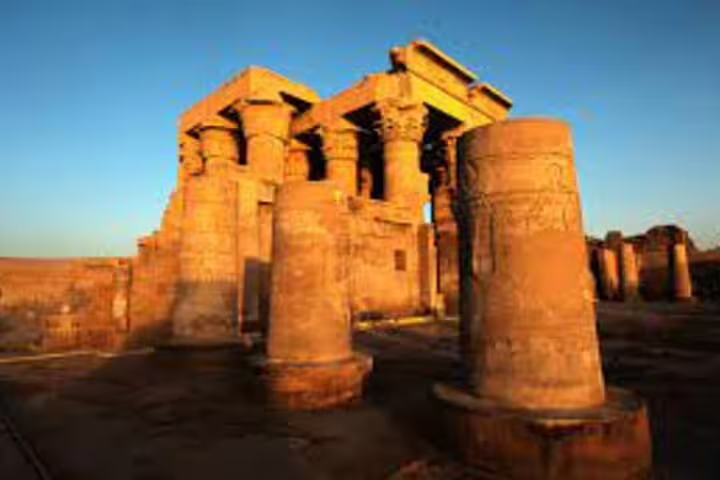 Golden sunrise view of Kom Ombo Temple pillars on Aswan to Luxor overnight trip including Edfu Temple visit